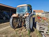 a tractor that is parked in the dirt