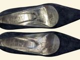 pair of women ' s black shoes on a white background