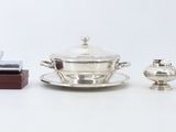 three pieces of silverware are sitting on a white surface