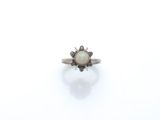 a close up of a ring on a white surface with a white background