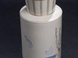a white vase with a blue and gold design on it