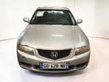 a silver car that is parked in a white room