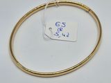 a close up of a gold bracelet with a tag on it