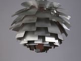 a metal light hanging from the ceiling in a room
