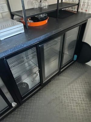 a black counter top with a glass door on it