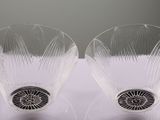 two wine glasses that are sitting on a table