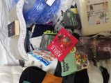 a bag full of items that are sitting on a bed