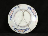 a white plate with a blue and orange design on it