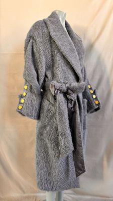 grey fur coat on mannequin stand with yellow buttons