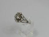 a close up of a diamond ring on a clear surface