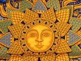 a close up of a sun with a ribbon around it