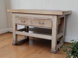 a small wooden table with two drawers on top of it