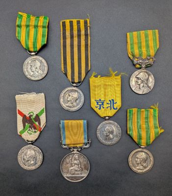 several medals and medals are displayed on a gray surface