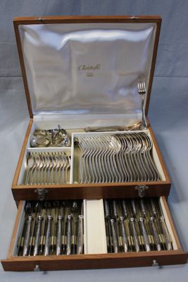 a wooden box with silverware in it on a table