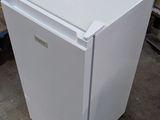 a white refrigerator that is sitting in a garage