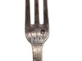 silver plated fork on a white background with a design on the fork