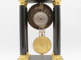 an image of a black and gold clock sitting on top of a table