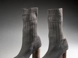 two pairs of gray socks with wooden heel on a white surface