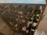 many bottles of wine in a metal rack on the floor