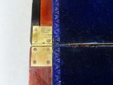 a close up of a blue case with a gold latch