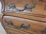 a wooden dresser with a drawer on top of it