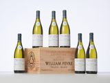six bottles of white wine in a wooden crate on a table