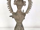 an image of a metal vase with a bird on it