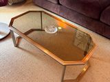 a coffee table with a glass top in the middle of a living room
