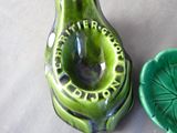 a green vase with a green lid next to a green bowl