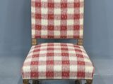a red and white checkered upholstered chair against a blue wall