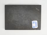 an old book with a sticker on it sitting on a white surface