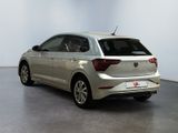 the rear of a silver car is parked in a white room