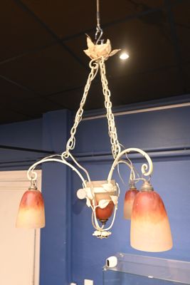 a chandelier hanging from the ceiling in a bathroom
