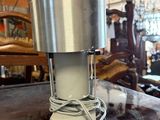 a silver cup sitting on top of a wooden table