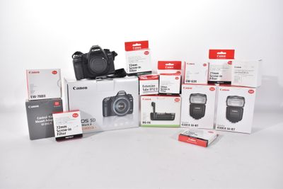 boxes of canon cameras are stacked on top of each other on a white surface