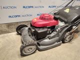an image of a lawn mower parked in a garage