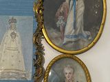 three framed pictures hanging on the wall of a room