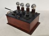 a small wooden box with four light bulbs on it