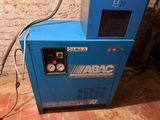 a blue machine that is sitting on a brick floor