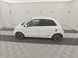 a picture of a small white car parked in a garage