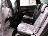 the back seats of a car with a wooden table in the back