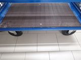 a blue cart that is sitting on a tiled floor