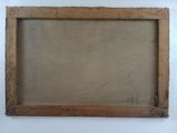 an old picture frame hanging on a wall next to a white wall