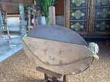 a wooden boat on a stand in a living room