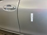 a silver car with a sticker on the side of it