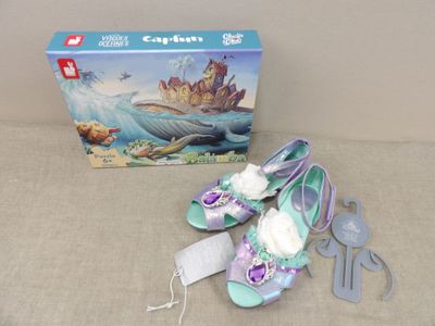 a box with a pair of shoes and a pair of scissors next to it