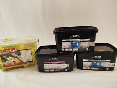 three containers of food sit on a white surface next to a package of food