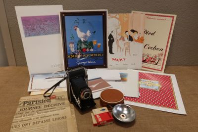 a table with a bunch of books and a camera on it