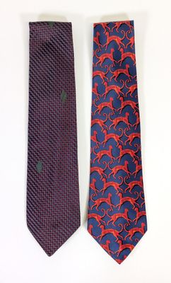 two ties with red and blue designs on them sitting next to each other
