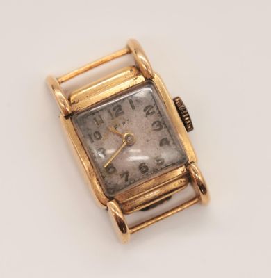 an image of a gold watch on a white surface
